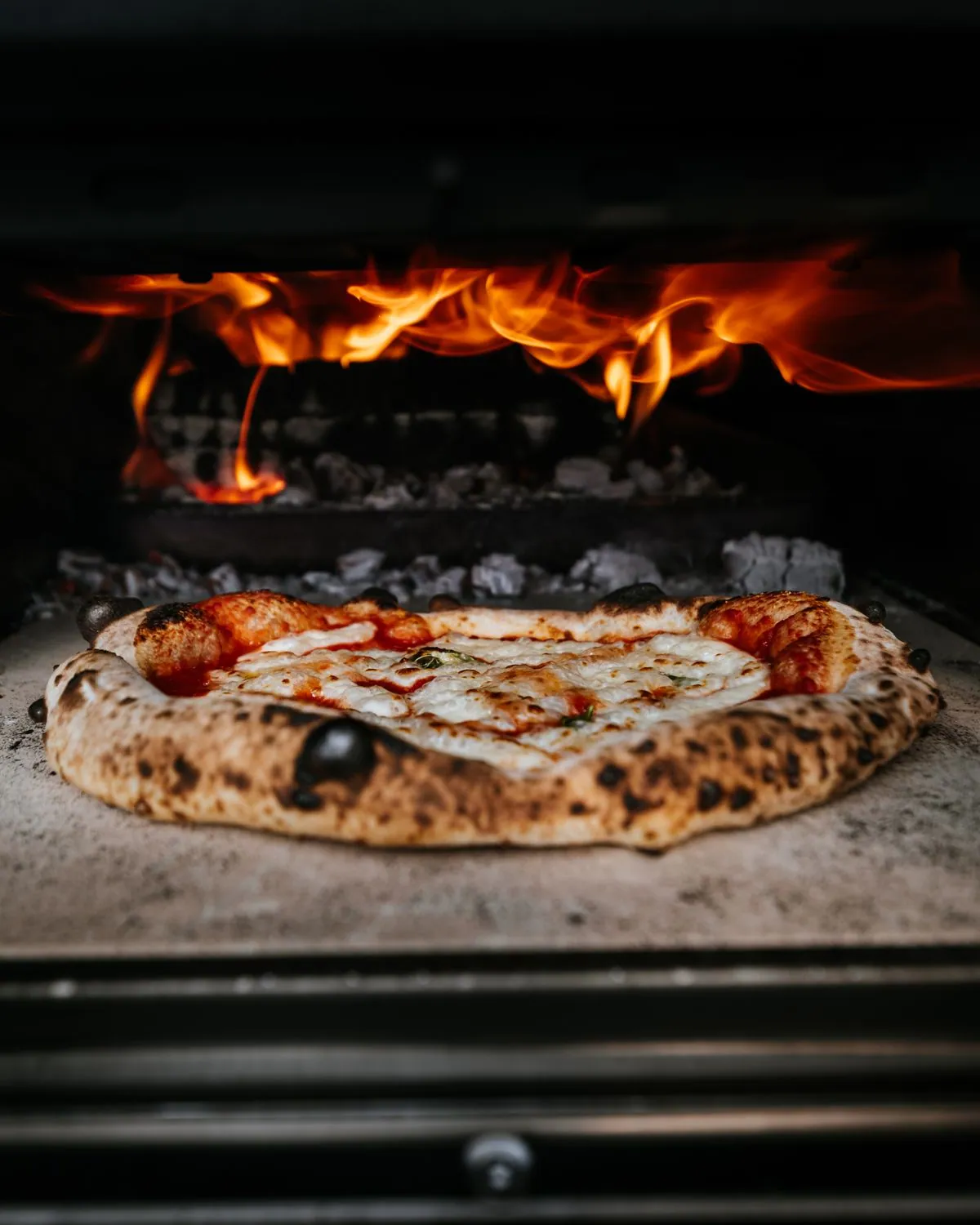 Enfants garnissant leurs mini pizzas lors d'un atelier anniversaire